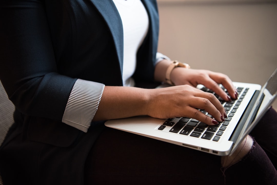 Business owner typing follow-up emails on a laptop